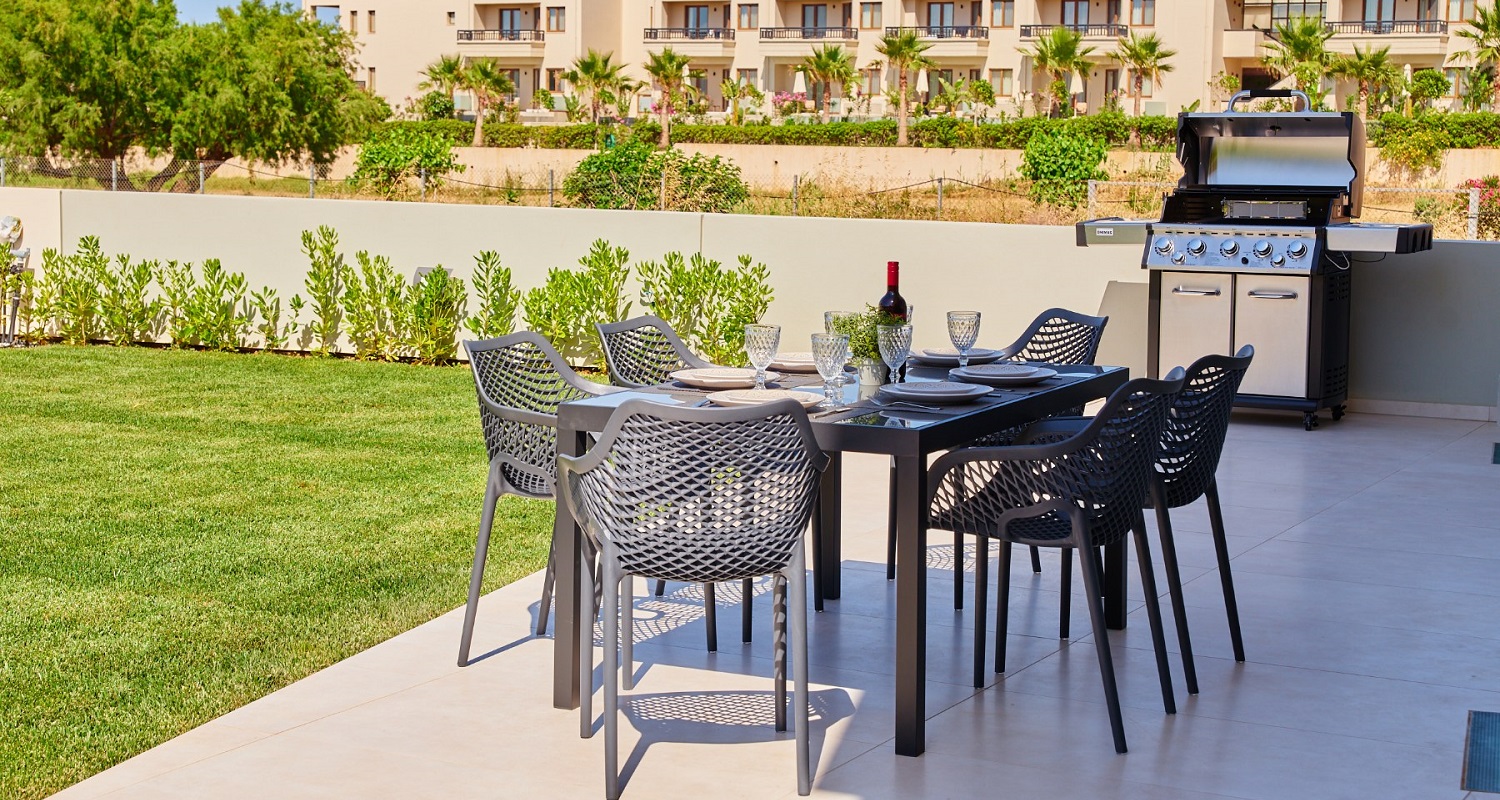 Photo of outdoor dining table and chairs in garden area